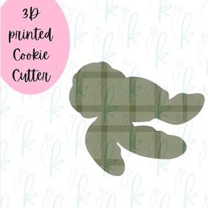 May include: 3D printed cookie cutter in the shape of a turtle. The cutter is green and has a plaid pattern.