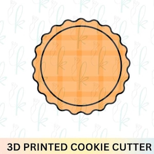 May include: A 3D printed cookie cutter with a scalloped edge. The cutter has a circular shape with a plaid orange interior and a black outline. The text "3D PRINTED COOKIE CUTTER" is at the bottom.