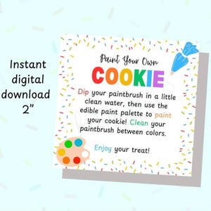 May include: A printable 2-inch square sign with a colourful paint your own cookie design. The sign says "Paint Your Own Cookie" and includes instructions to dip a paintbrush in water and use edible paint to decorate a cookie. The sign also includes a colourful paint palette.