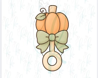 May include: A 3D printed cookie cutter shaped like a pumpkin rattle with a light orange pumpkin top, a sage green bow, and a light tan handle. The design features a small leaf and vine detail on the pumpkin. The text 3D PRINTED COOKIE CUTTER is visible.