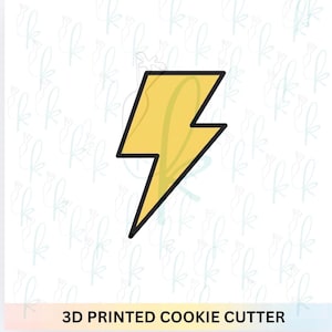 May include: A yellow lightning bolt cookie cutter with a black outline. The cookie cutter is 3D printed. The background is white with a repeating pattern of light blue floral designs. The text "3D PRINTED COOKIE CUTTER" is at the bottom.