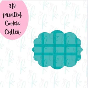 May include: A teal 3D printed cookie cutter in a scalloped rectangular shape with a grid pattern. The text "3D printed Cookie Cutter" is in black on a pink oval background.