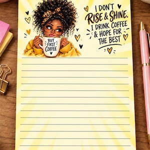 May include: A rectangular notepad with a yellow sunburst background featuring an illustration of a person with curly hair wearing a leopard print headband and glasses, holding a mug that says BUT FIRST COFFEE. Text reads I DON'T RISE & SHINE.
