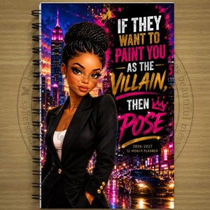 May include: A spiral-bound 2026-2027 12-month planner featuring an illustration of a person in a black blazer against a city skyline. The text reads: IF THEY WANT TO PAINT YOU AS THE VILLAIN, THEN POSE. A sports car is visible in the foreground.