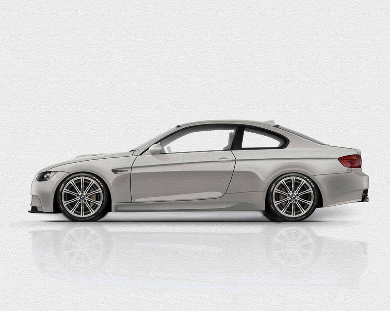 May include: A silver grey coupe car with black tinted windows and black rims. The car is parked on a white surface.