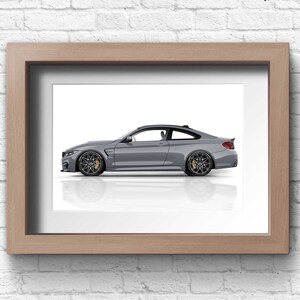May include: A framed photograph of a silver grey sports car on a white background. The car is in profile view, with the driver's side facing the viewer.