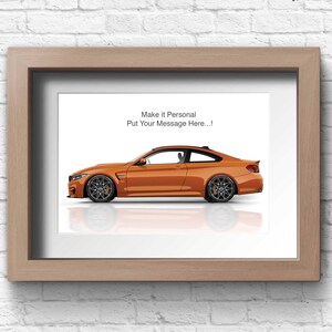 May include: A framed print of an orange BMW M4 with a white background. The text "Make it Personal Put Your Message Here..." is at the top of the print.