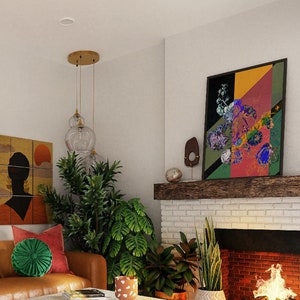 May include: A living room with a brown leather sofa, a white coffee table, and a brick fireplace. The sofa has red and green pillows and a rug with a red and white pattern. There are plants in the room and a painting on the wall.