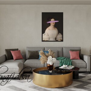 May include: A gray sectional sofa with two pillows, a green throw blanket, and a gold coffee table with a black marble top. A vase with dried flowers sits on the table. A framed portrait of a woman with a purple stripe over her eyes hangs on the wall behind the sofa.