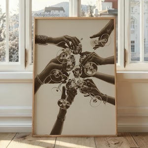 May include: Sepia-toned print of hands holding champagne glasses in a celebratory toast. The image is framed in a light wood frame and set against a neutral background. The text "thebonafideso" is visible in the upper left corner.