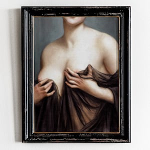 May include: A framed oil painting of a woman's torso, with her hands holding a sheer fabric draped over her chest. The painting is in a dark wood frame.