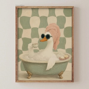 May include: A framed wall art print featuring a white duck in a clawfoot bathtub filled with bubbles. The duck wears a pink towel wrap on its head and dark round sunglasses while holding a small teacup. The background has a green and cream checkerboard pattern.