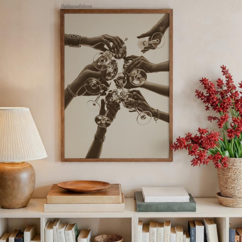 May include: Sepia-toned framed print featuring a celebratory toast with wine glasses. Multiple hands are raised, holding the glasses in a clinking gesture. The image is set against a neutral background, creating a classic and elegant aesthetic.