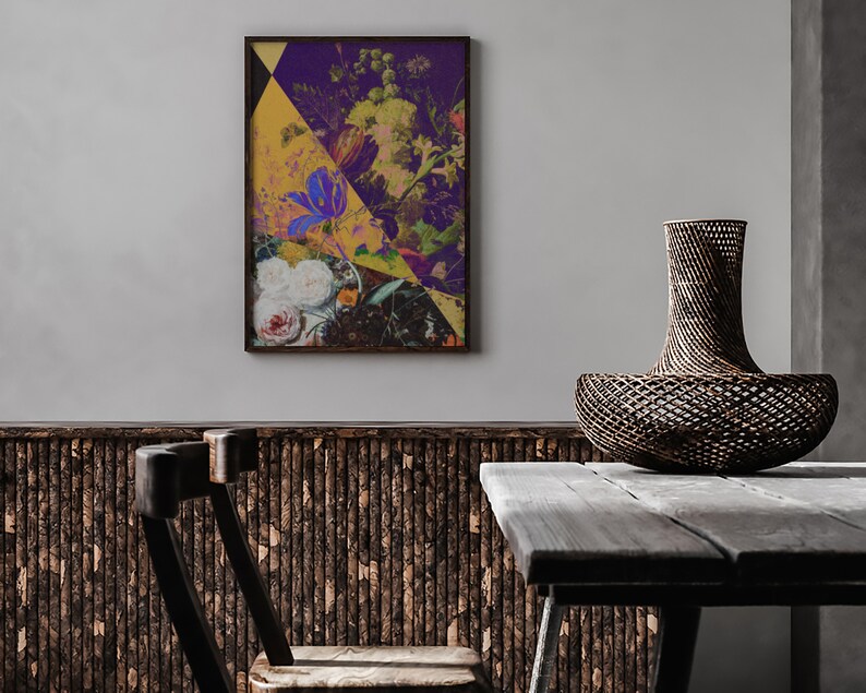 May include: A framed abstract floral print with a yellow, purple, and green color scheme hangs on a white wall above a wooden table and a woven basket.