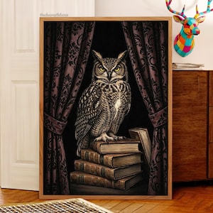 May include: A framed print featuring a detailed illustration of a great horned owl perched atop a stack of old books. The owl is depicted in shades of brown and white, set against a dark background with ornate, dark purple curtains. The artwork has a vintage, scholarly aesthetic.