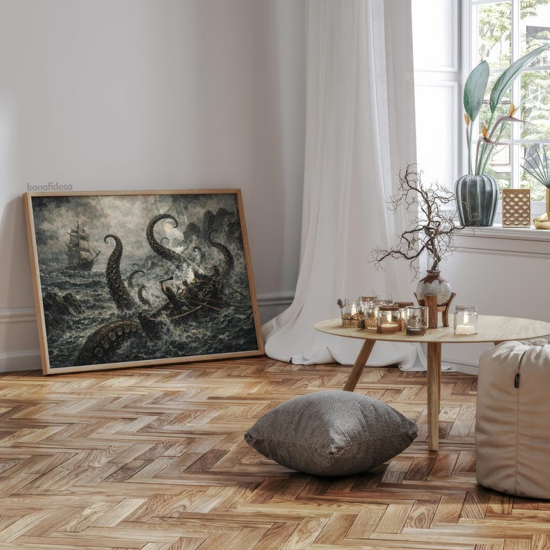 May include: A framed print depicts a dramatic sea battle with a ship and a giant octopus. The artwork is in shades of gray and black, with a wooden frame. The print is leaning against a white wall on a wooden floor.