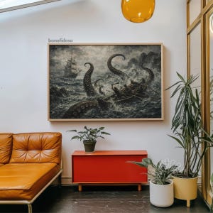 May include: A framed artwork depicts a dramatic sea battle with a ship and a boat under attack by a giant octopus. The artwork is in a wooden frame and hangs above a red cabinet and a brown leather sofa. The artwork is signed "bonafidesa".