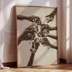 May include: Sepia-toned framed print featuring multiple hands holding champagne glasses in a celebratory toast. The artwork has a vintage aesthetic, with the hands adorned with jewelry. The print is displayed against a neutral wall, adding to its classic appeal.