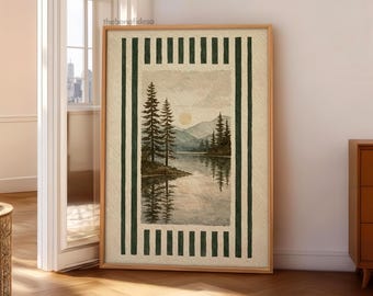 May include: A framed watercolor print of a serene lake scene with pine trees, mountains, and a setting sun. The artwork is bordered by a green and cream striped pattern, and the frame is a light wood color.