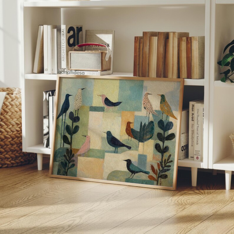 May include: A framed art print featuring a colorful, abstract illustration of various birds. The artwork showcases birds in shades of blue, brown, pink, and green, set against a geometric background of muted colors. The print is displayed on a wooden shelf.