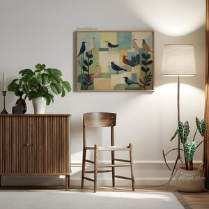 May include: A framed artwork featuring stylized birds in various colors against a geometric background. The artwork hangs above a wooden chair and cabinet. A floor lamp and potted plants complete the room's decor. The text "bonafidesa" is in the top left corner.