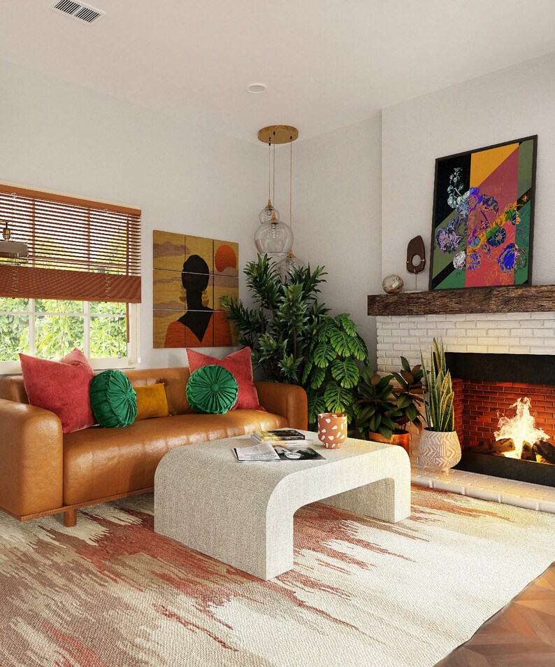 May include: A living room with a brown leather sofa, a white coffee table, and a brick fireplace. The sofa has red and green pillows and a rug with a red and white pattern. There are plants in the room and a painting on the wall.