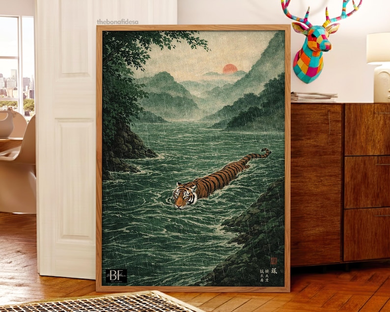 May include: A framed art print showing a tiger swimming in a river, with mountains and a setting sun in the background. The artwork is in a traditional Japanese style, with a wooden frame.