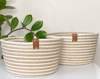 Set of storage baskets made of jute and cotton cord. Two baskets with a handle for storing laundry