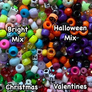 May include: A selection of colourful plastic beads, including Halloween, Christmas, Valentine's Day, and bright mix themes. The beads are arranged in a pile and include letters, shapes, and designs.