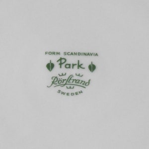 Puede incluir: Plato de cer&aacute;mica blanca con texto y logotipo verdes. El texto dice "FORM SCANDINAVIA Park R&ouml;rstrand SWEDEN". El logotipo presenta un dise&ntilde;o de hoja. El plato probablemente forma parte de un juego de vajilla.