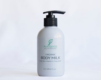 May include: A white bottle of organic body milk with a black pump dispenser. The bottle has a green leaf logo and the text "PURISENSE organic skincare" and "ORGANIC BODY MILK Green Tea Vitamin E Shea Butter 250 ml (8.5 fl oz)".