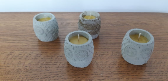 concrete owl container holding beeswax candle