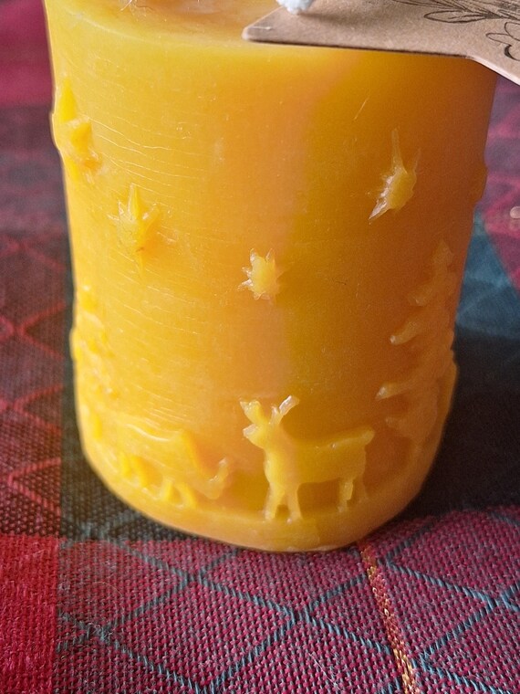 beeswax candle with winter seen carved into sides