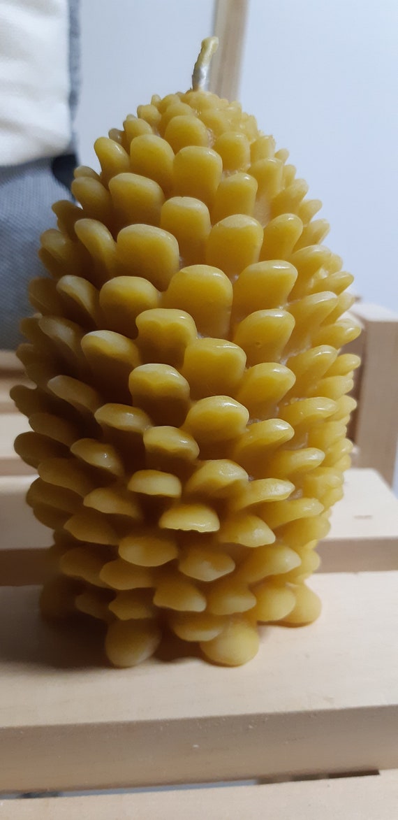 hand poured beeswax candle in shape of pine cone