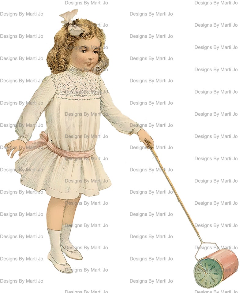 May include: A young girl in a white dress with a pink sash pulls a toy lawnmower with a green and white design. The lawnmower has a pink and white handle and a red and white drum. The girl has a white bow in her hair and is smiling.