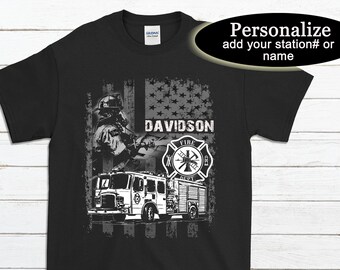 May include: Black t-shirt with a white graphic of a firefighter, fire truck, and American flag. The text "DAVIDSON" is printed on the shirt.