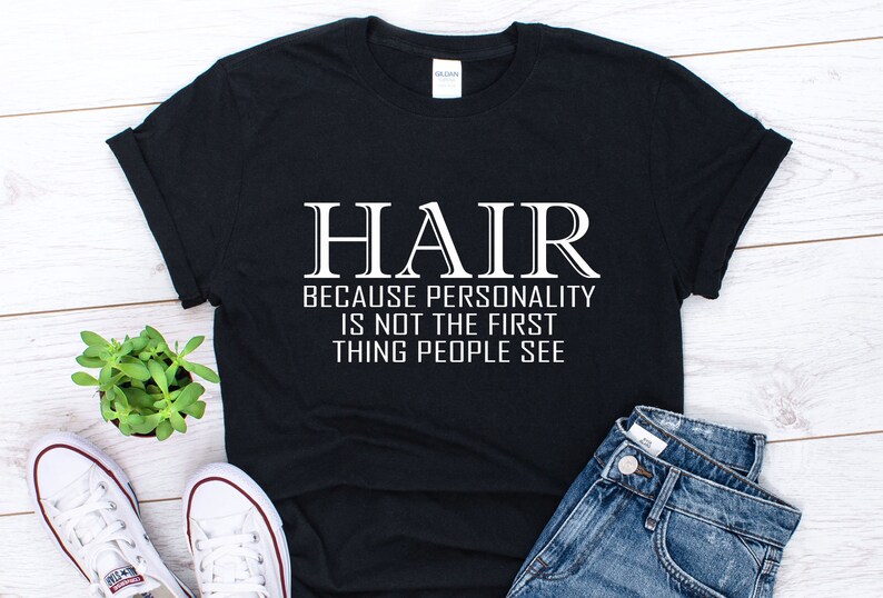 May include: Black t-shirt with white text that reads "HAIR because personality is not the first thing people see".