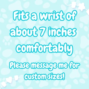 May include: A light blue background with white paw prints and marshmallow-shaped decorations. Text in turquoise reads: "Fits a wrist of about 7 inches comfortably. Please message me for custom sizes!"