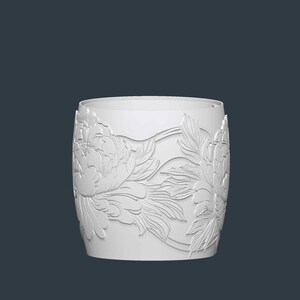 May include: A white cylindrical vase with a detailed floral relief pattern. The design features large peony blossoms and leaves, creating a textured surface. The vase has a smooth, unadorned rim and a dark background.