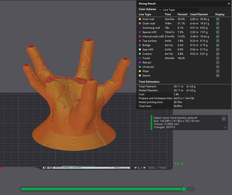 May include: A 3D-printed orange hand-shaped jewelry plate. The design features five fingers with textured surfaces and red accents on the fingertips. The plate is displayed against a dark grid background.