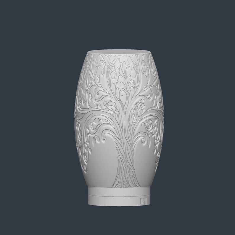 May include: A white, oval-shaped decorative vase with a detailed tree of life design carved into its surface. The vase has a wide base and a slightly narrower top. The intricate carvings feature branches, leaves, and other organic elements.
