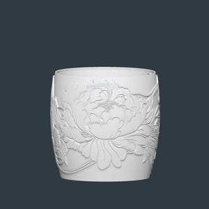 May include: A white cylindrical container with a detailed relief of a peony flower. The floral design wraps around the container, showcasing petals and leaves. The background is a solid, dark blue-gray.