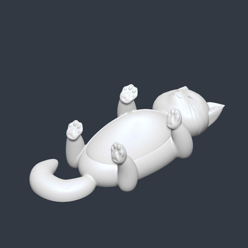May include: A white, stylized cat figurine lying on its back with its paws in the air. The cat has a rounded body, a curled tail, and detailed facial features. The background is a solid, dark gray.