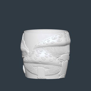 May include: A white, cylindrical ceramic planter with a detailed mushroom design. The planter features a textured surface with embossed mushroom caps and gills, creating a whimsical, nature-inspired aesthetic. The design includes various mushroom shapes and sizes.