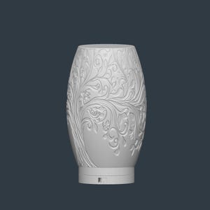 May include: A white, oval-shaped decorative vase with an intricate tree and floral relief design. The vase has a smooth, rounded top and a base with a small rectangular opening. The detailed carvings create a textured surface.