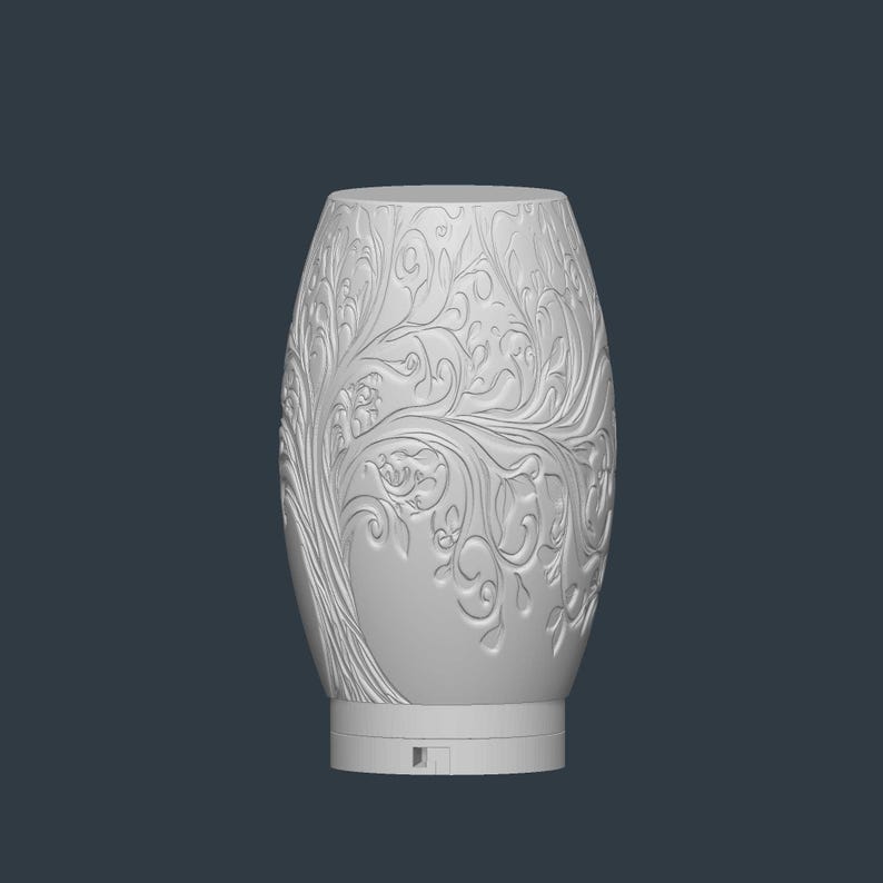 May include: A white, oval-shaped decorative vase with an intricate tree and floral relief design. The vase has a smooth, rounded top and a base with a small rectangular opening. The detailed carvings create a textured surface.