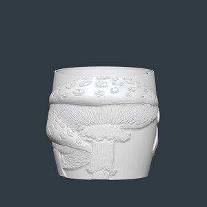 May include: A white, cylindrical container with a detailed relief of a mushroom design. The mushroom features a textured cap with small, raised spots and a detailed stem. The container is likely for home decor.