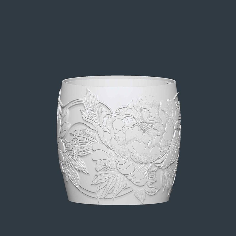 May include: White cylindrical container with a detailed embossed floral design. The design features a large peony flower and leaves, creating a textured surface. The container has a smooth, rounded rim and a dark background.