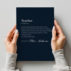 May include: A navy blue print with the definition of "Teacher" in white text. The definition includes the phonetic pronunciation, and a description of a teacher's qualities. The print is also personalized with the name "Mrs. Anderson".
