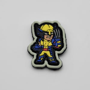May include: A yellow, blue and black cartoon character with claws and a yellow and red belt. The character is wearing a blue and black suit. The character is on a white background.